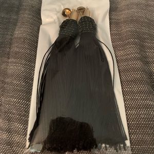 Long black tassel with gold accents